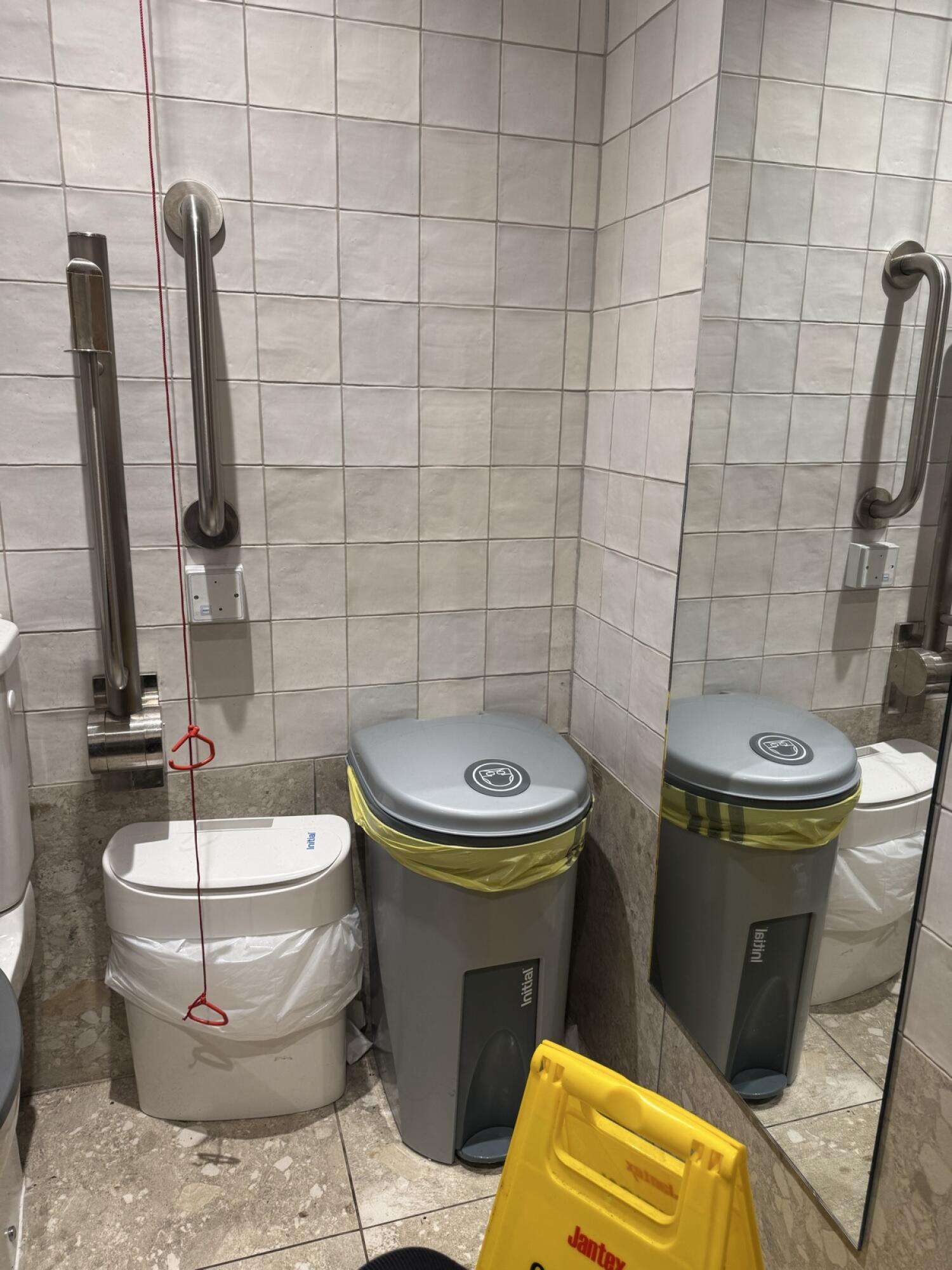 Emergency pull cord to left of bins. Small bin left of larger bin.