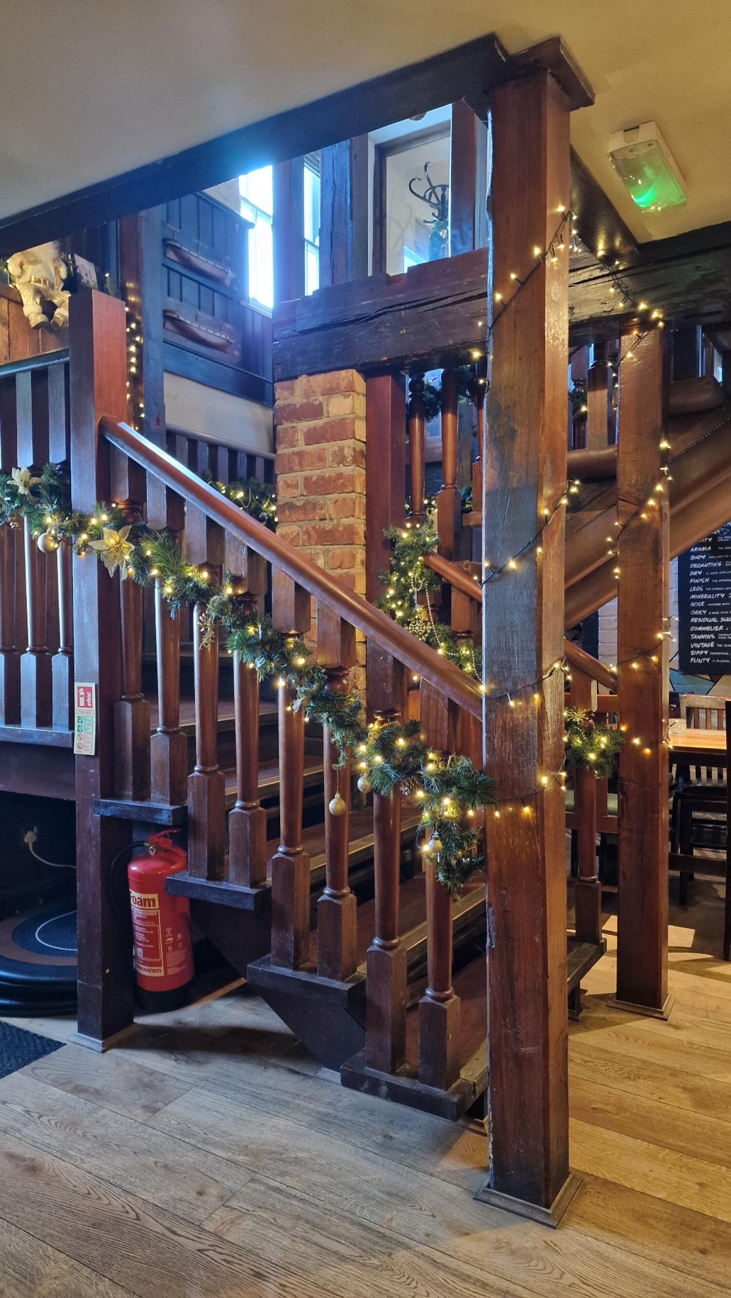Staircase ahead, leading up. Handrails along left and right.