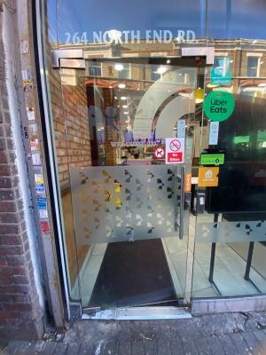 Glass door with glass frames ahead. Push from right to open.