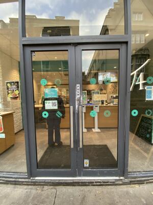 Grey framed glass door. Push silver metal handle from centre to open.