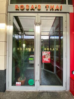 Glass doors with grey metal frames ahead. Pull from center to open.