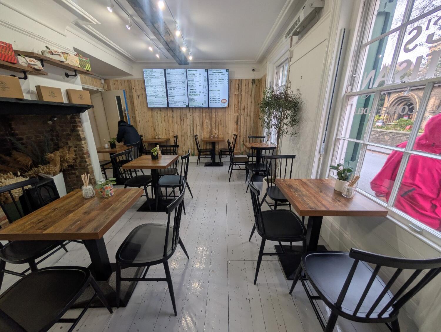From entrance facing right. Tables and chairs along both sides and back.