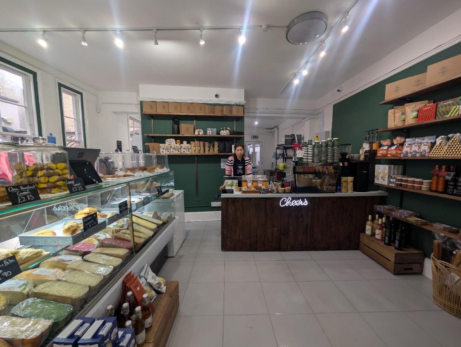 From archway facing straight. Food display along left. Counter at back right.