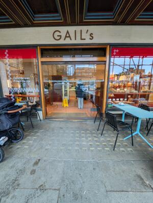 Full glass doors in front. Gold handles in center. Push to open.
