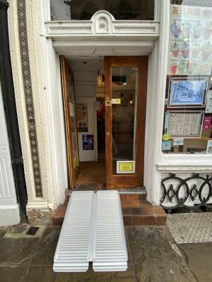 Brown wooden framed glass doors. Push from centre to open.