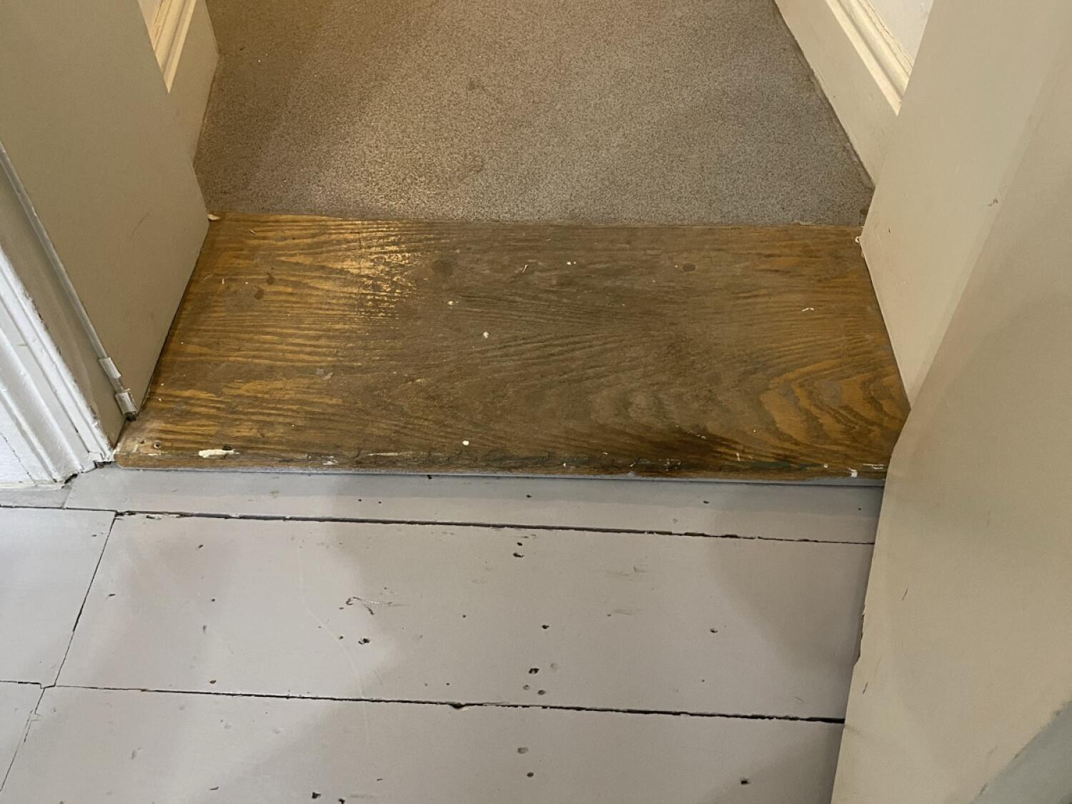 Wooden bump at door foot.