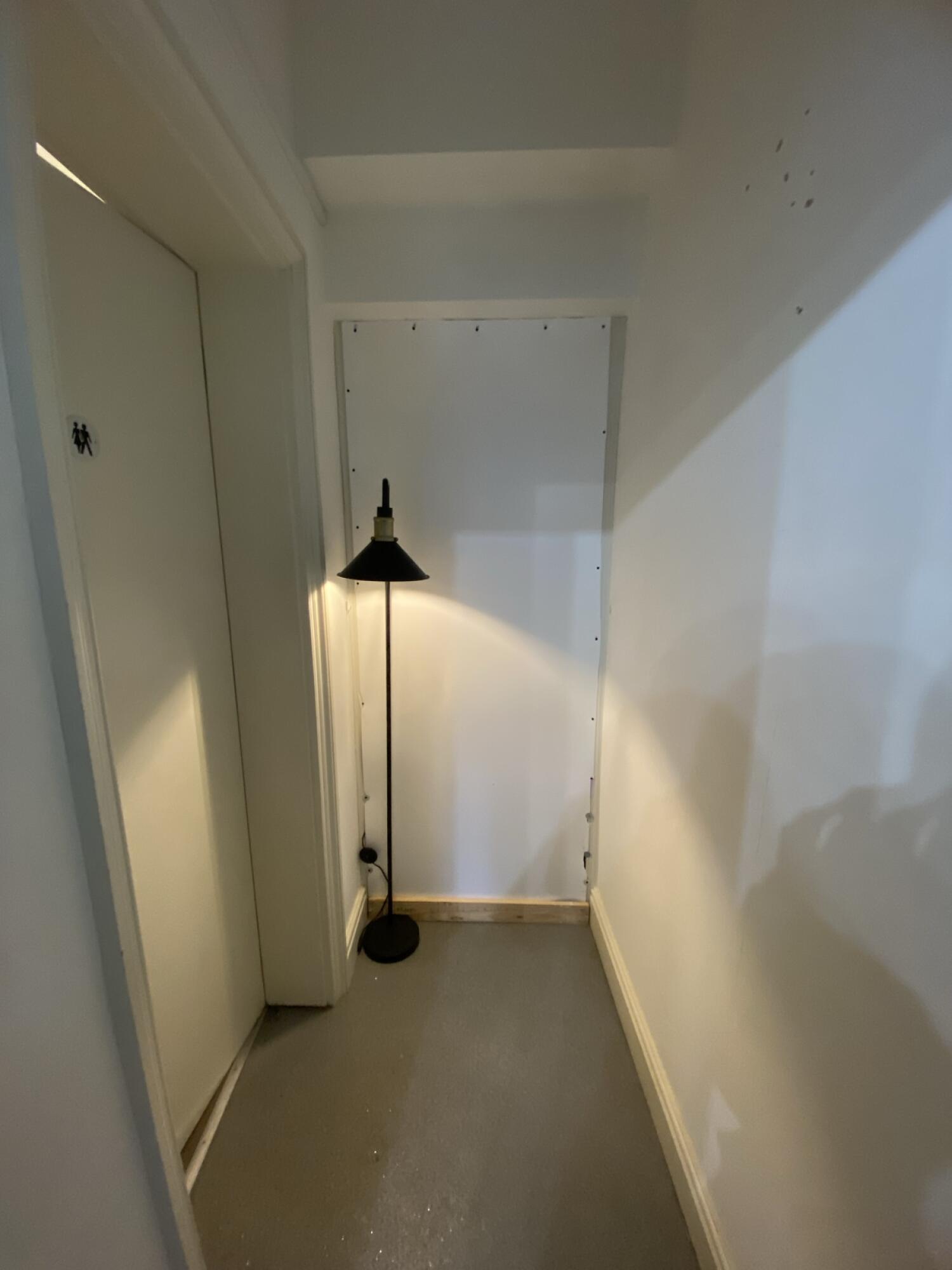 From after door facing straight. Pathway ahead. Bathroom door on left.
