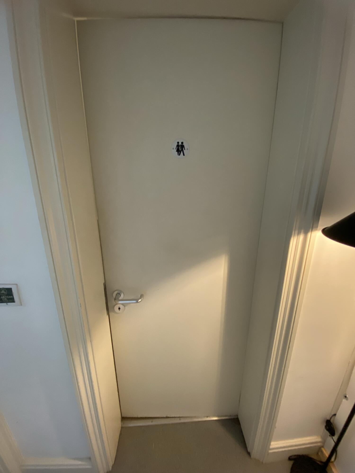 From end of pathway facing left. Turn silver metal handle and push from left to open.