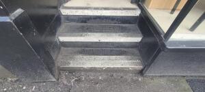 Three steps up before door.