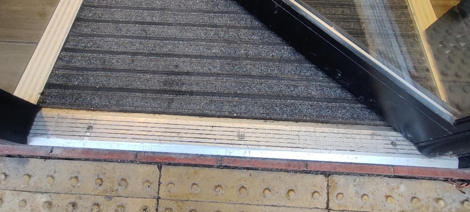 Small metal bump ahead. Doormat beyond.