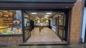 Black metal-framed glass doors. Push in center to open.