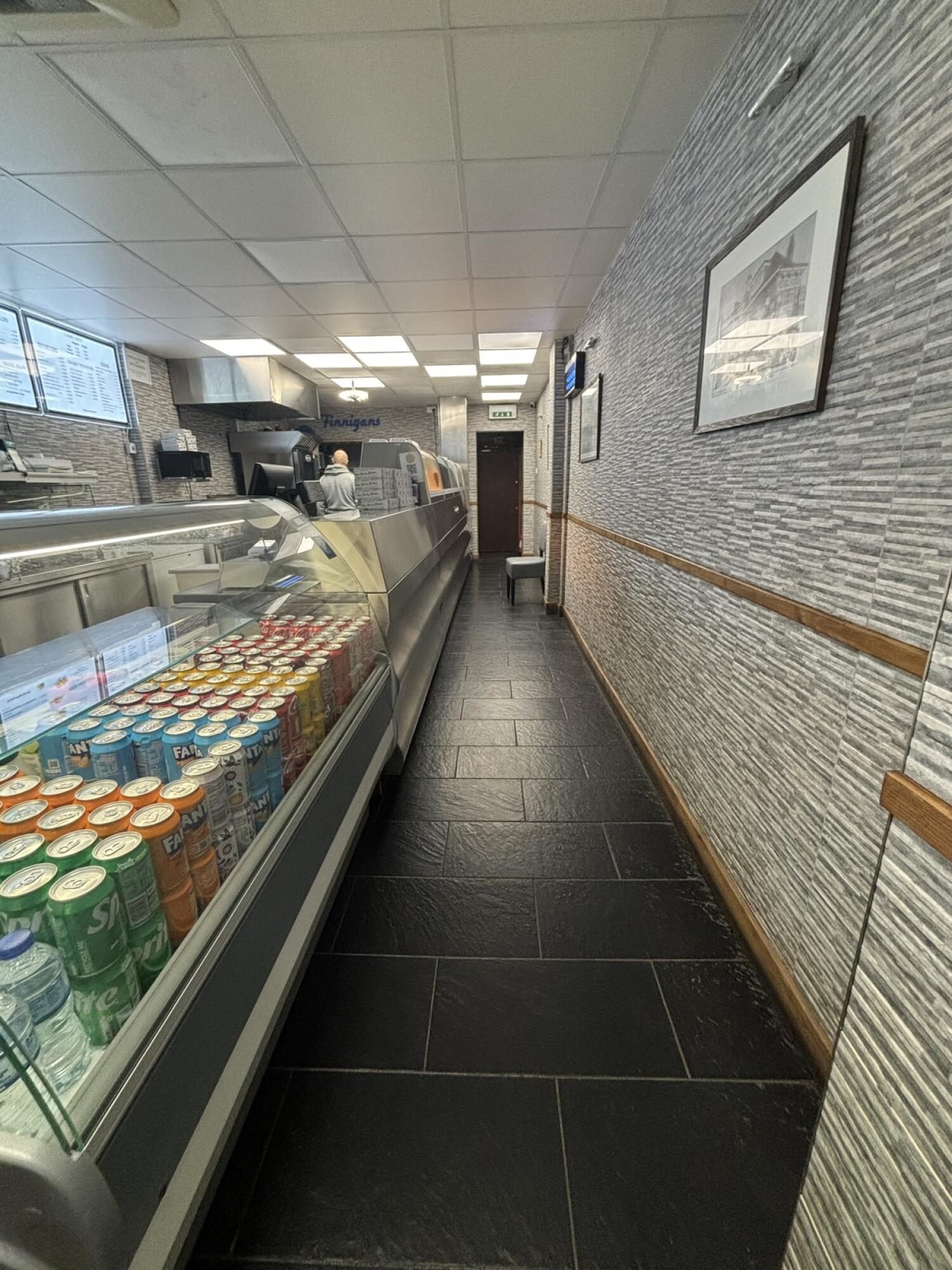 From top of stairs facing straight. Counter along left. Path ahead to toilet at back.