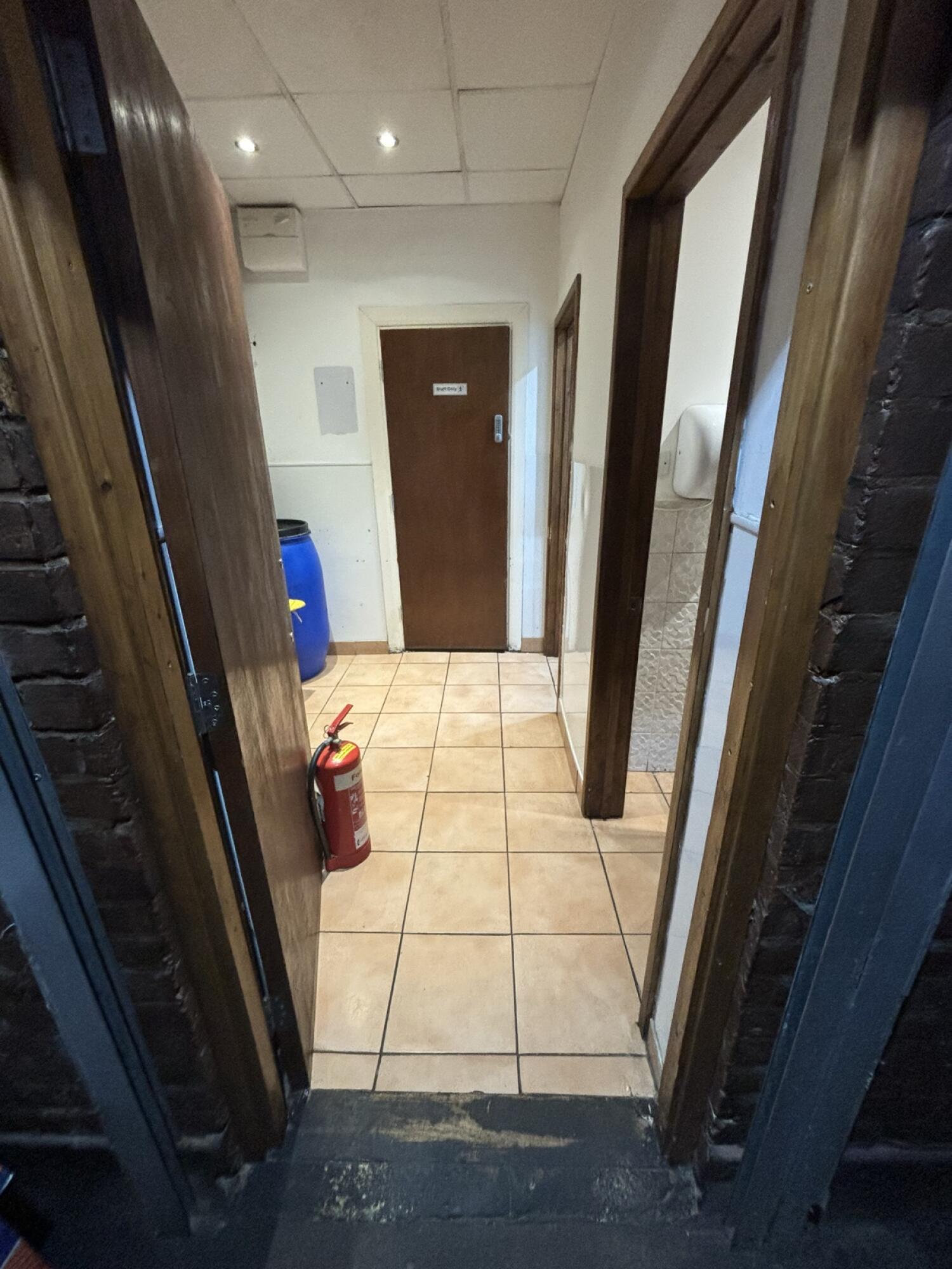 Form end of path facing left. Brown door ahead to toilet. Push from right to open.