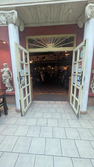 Cream wood-framed glass doors. Pull from handles at centre to open.
