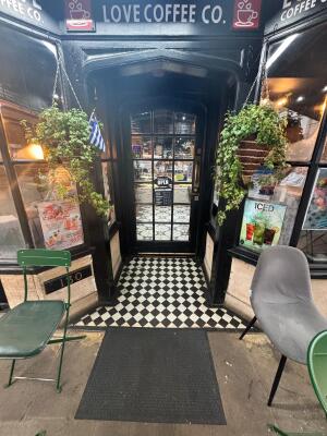 Archway with black wooden frames ahead.