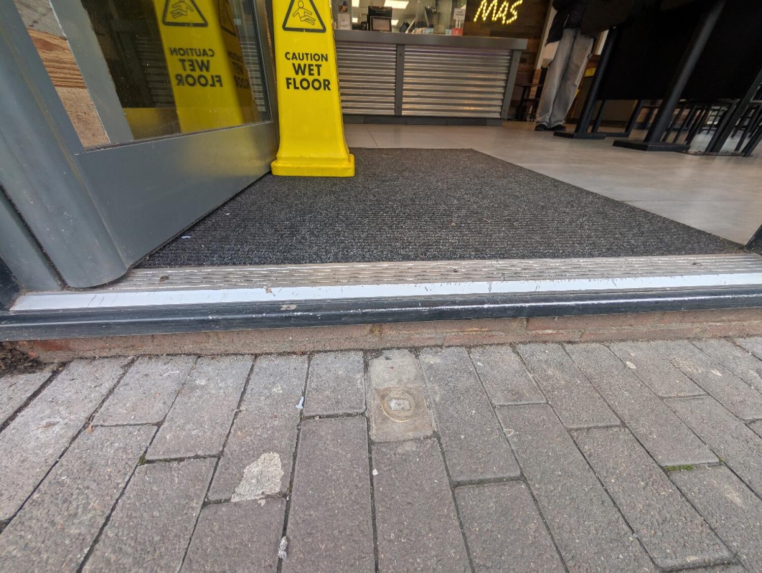 Step at entrance. Doormat after.
