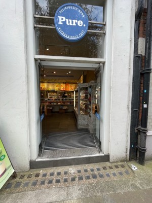 Glass double doors with handle in centre, push to open.