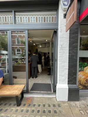 Glass door with black dooframe. Silver handle to left, push to open.
