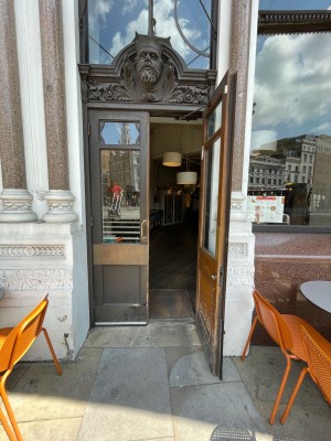 Wooden glass double doors, handle in centre. Pull to open.