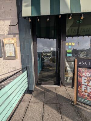 Black frame glass door in front. Silver handle on right. Push to open.