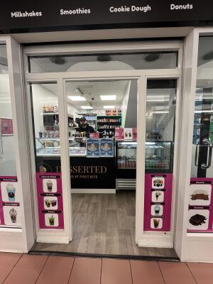 White-framed glass doors. Push from handle on left to open.