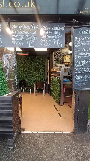 Open entrance to venue. Planter on left.