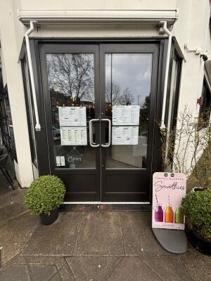 Dark brown framed glass doors ahead. Push handles in centre to open.