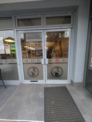 Grey frame glass doors in front. Silver handle on centre. Pull to open.