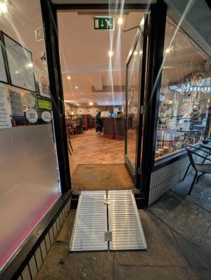 Black frame glass door at front. Push from left to open.