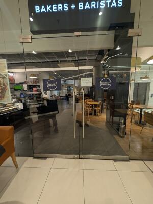 Full glass doors in front. Silver handle on center. Pull to open.