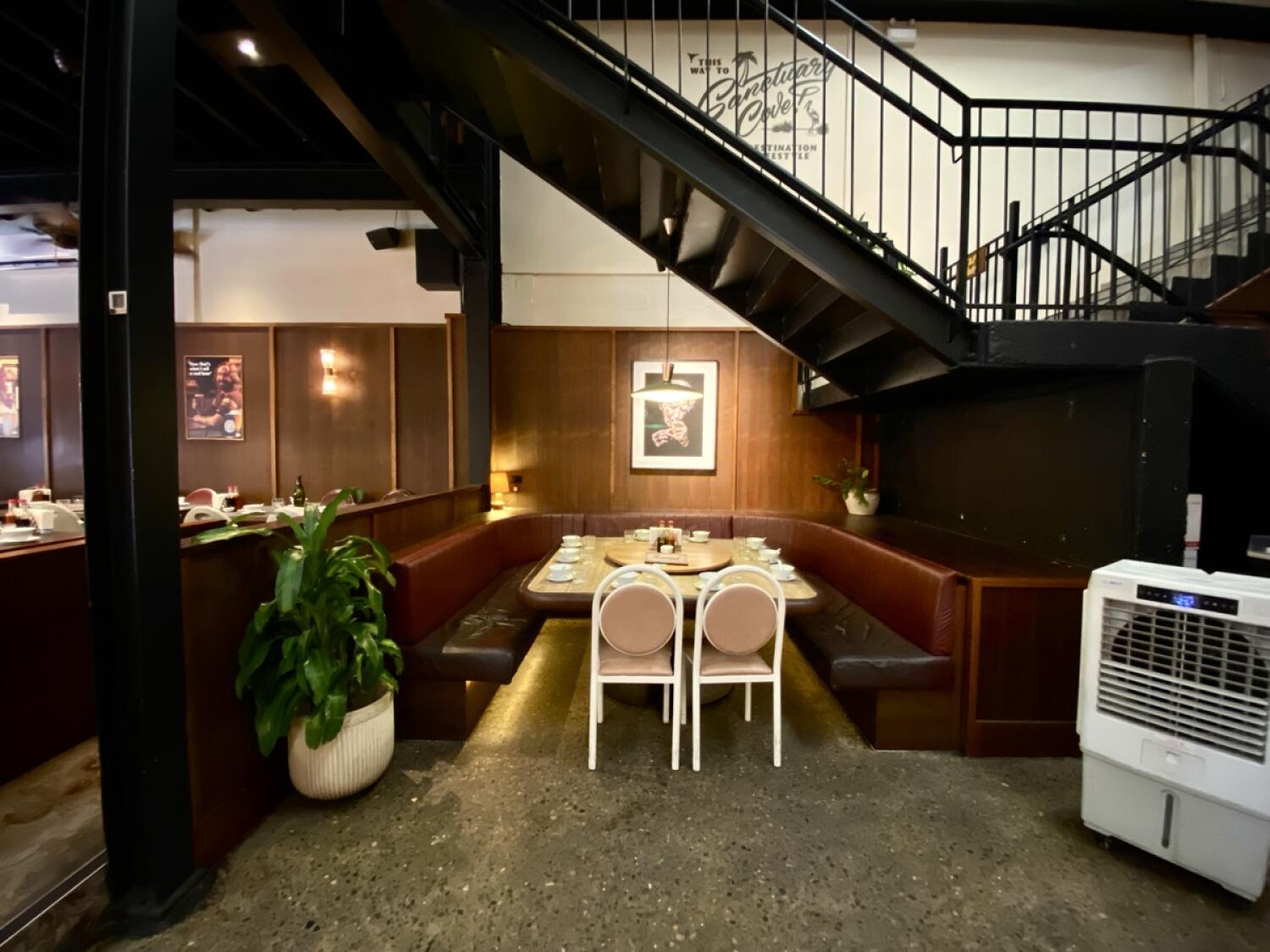 From opening facing left. Round half booth and chairs ahead.