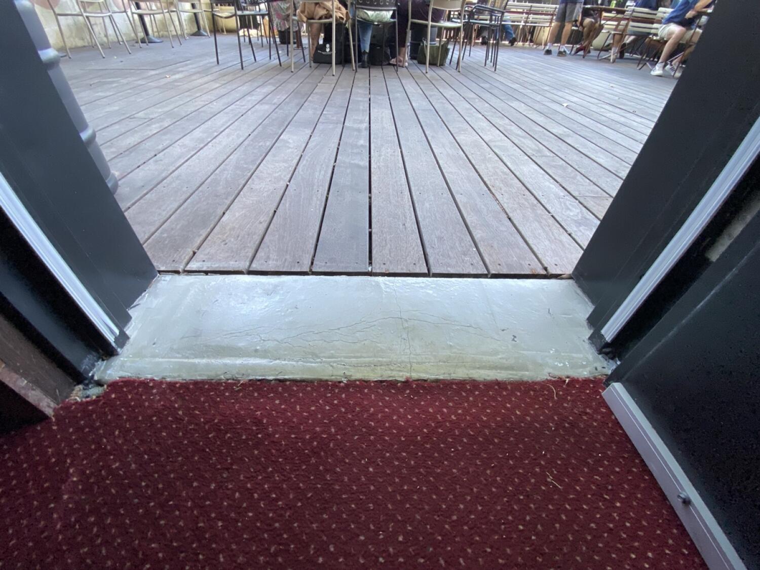 Small bump at foot of door. Deck flooring following.