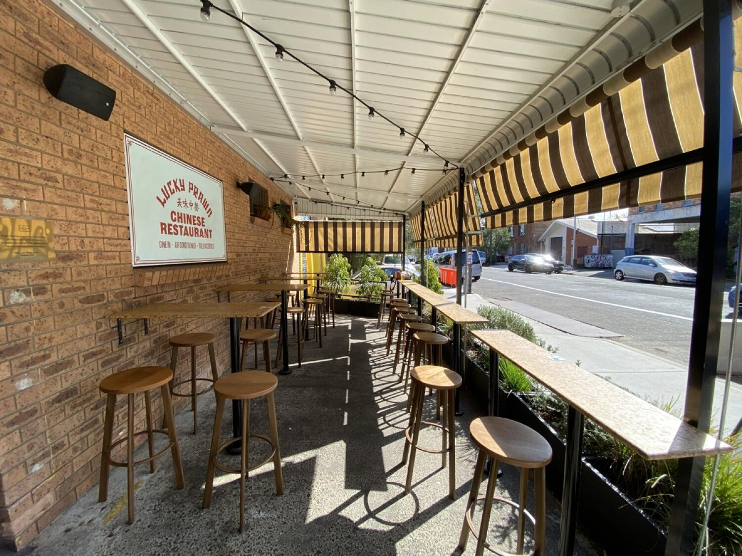 From entrance opening facing right. Bar tables with stools along left and right.