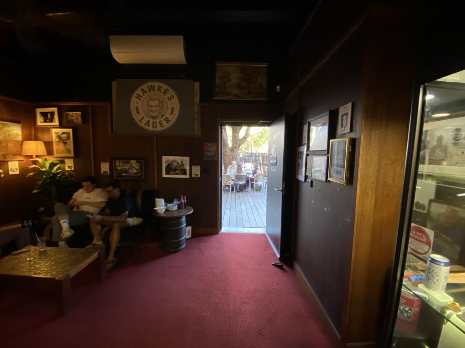 From end of pool table facing straight. Couches along back left. Door ahead to outdoor back area.