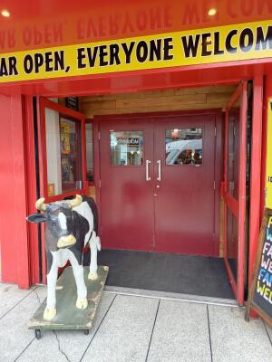 Red glass double doors. Push from handles at centre to open.