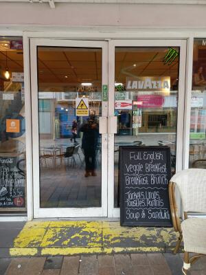 White metal-framed glass doors. Push from handle at centre to open.