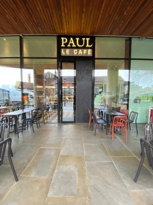 Glass doors with black frame ahead. Pull from silver metal handle in centre to open.