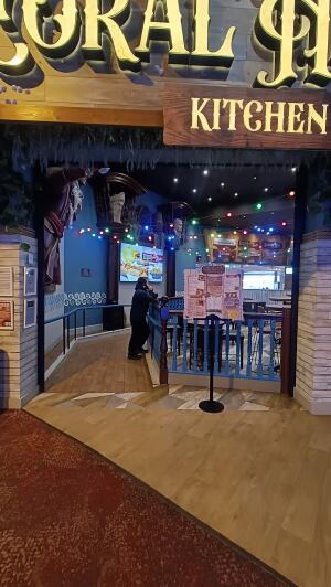Open archway to venue with welcome desk in right.