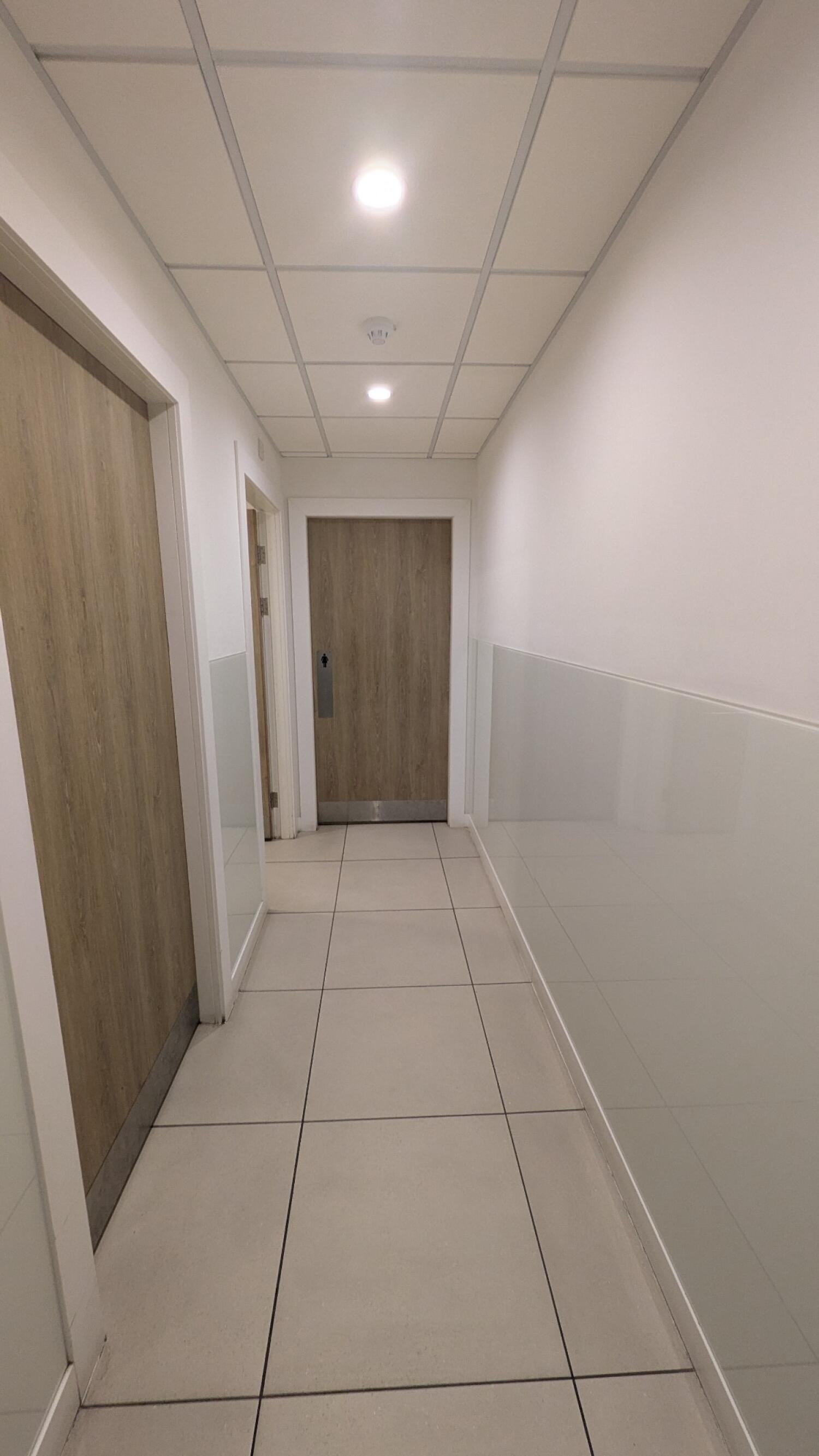 From door facing right. Door on left at end of path.