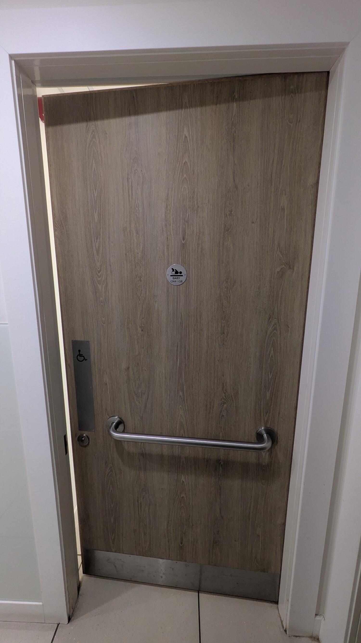 From end of path facing left. Grab rail in centre. Push from metal handle on left to open.