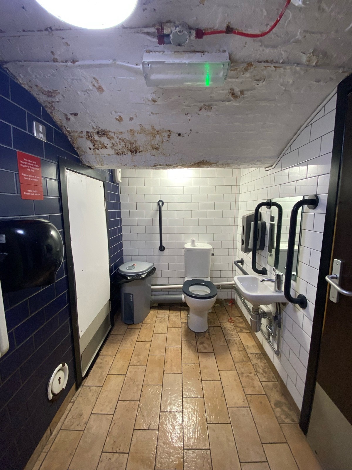From doorway facing right. Toilet ahead. Sink on right. Emergency pull cord to right of toilet.