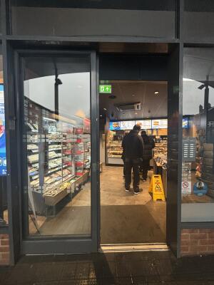 Grey metal-framed glass doors ahead. Slide door from right to left to open.