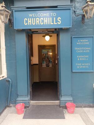 Black wooden doors ahead. Push from handles at centre to open.