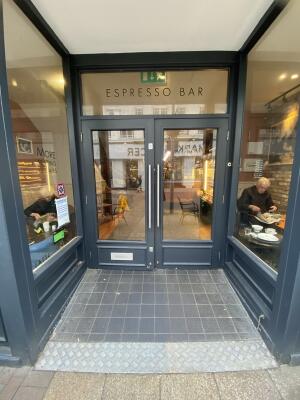 Black-framed glass doors. Pull from silver metal handles at centre to open.