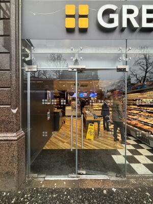 Glass doors ahead. Push handles in centre to open.