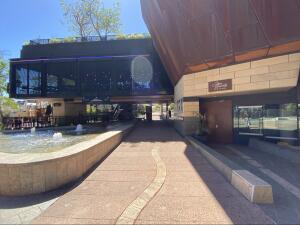 Pathway ahead leading to main entrance. Fountain on left.