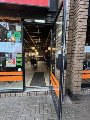 Black metal-framed glass door. Pull from handle on left to open.