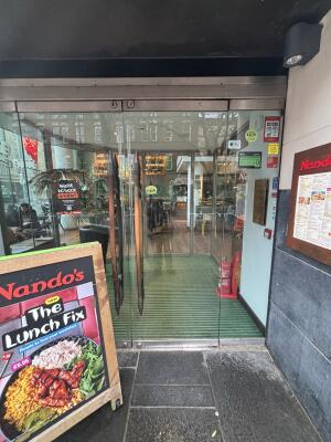 Glass doors with wooden handle ahead. Push to open.