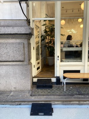 Facing venue. Two steps up to entrance door on back.
