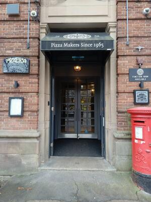 Black wooden door ahead. Push from handles at centre to open.